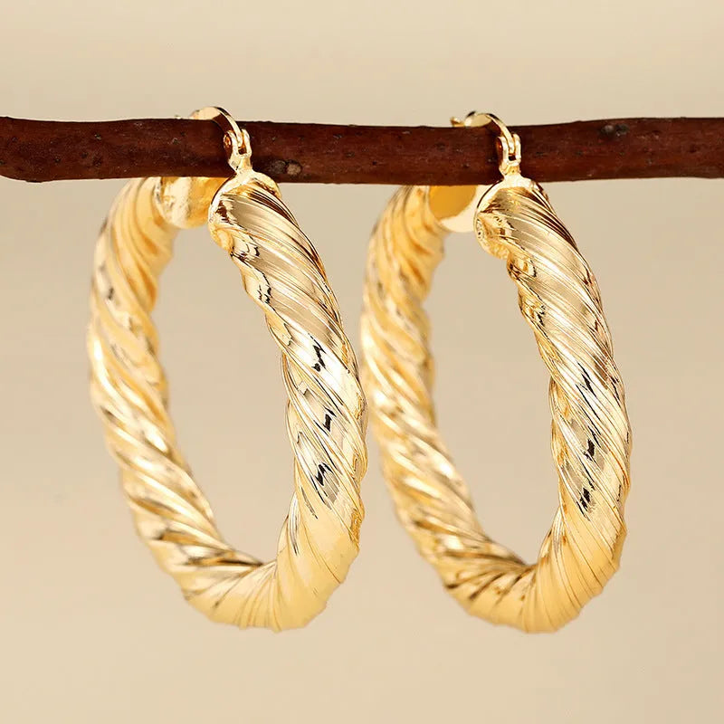 Geometric drop-shaped ear clips with ring and line design in metallic finish