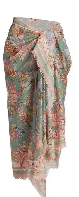 Women's creamy-white floral print bikini set with top, briefs, and skirt laid flat.
