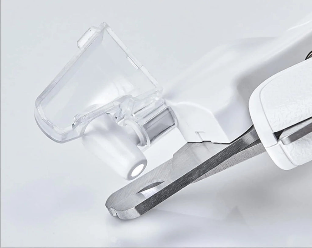 White LED pet nail clippers with transparent guard open, showing triangular steel blades and a nail file.