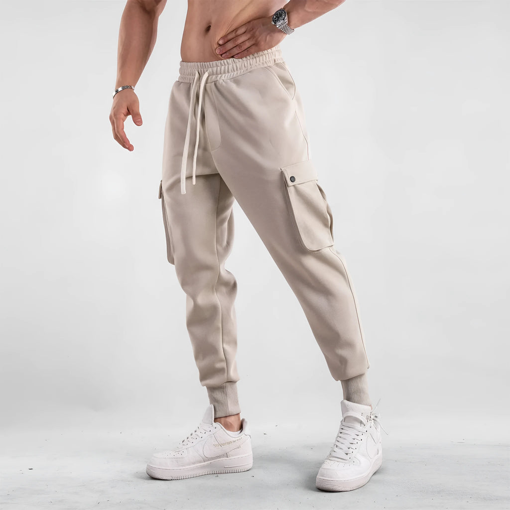 Men's loose cotton trousers with ankle ties and multiple pockets in solid apricot colour