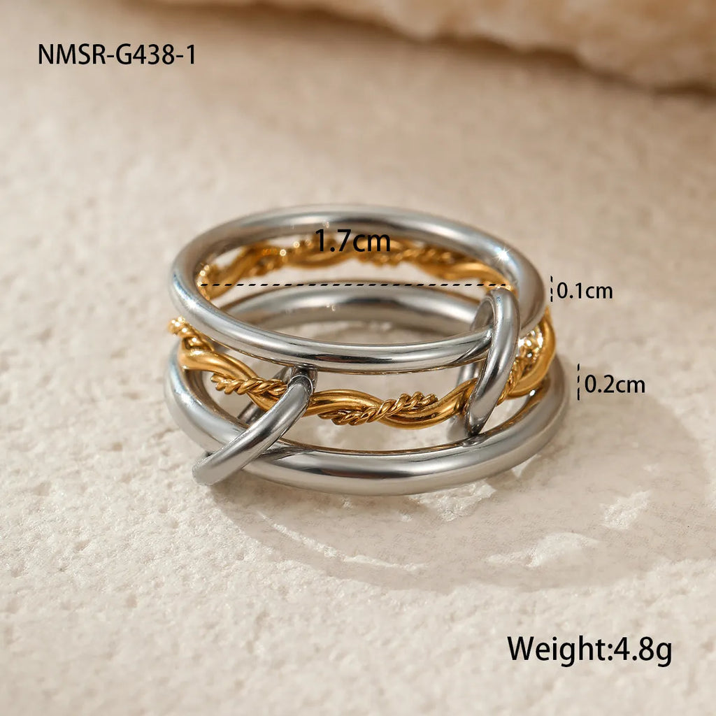 Gold plated stainless steel stacked ring set in three colour variants on a hand.