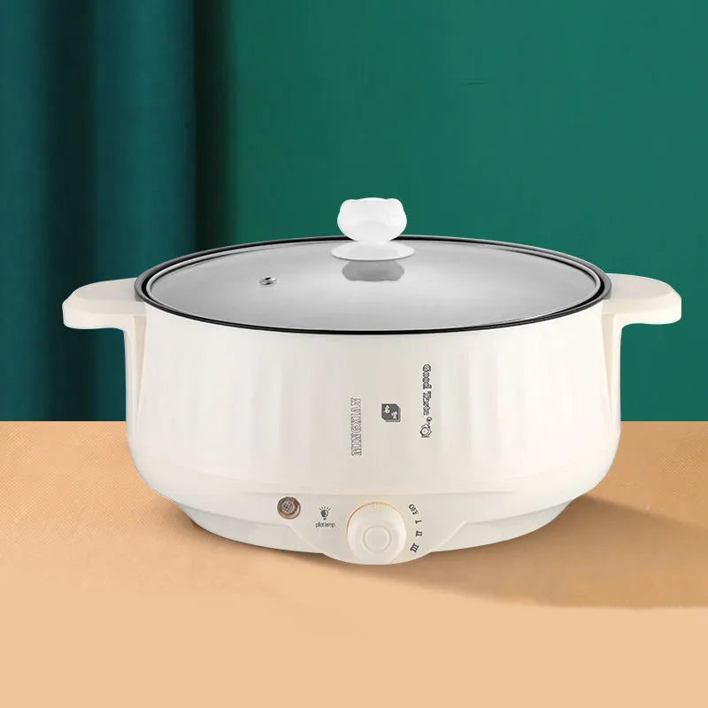 White electric hot pot with non-stick interior and UK plug on kitchen counter