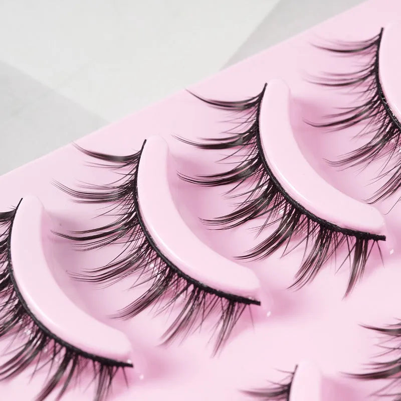 Five pairs of wispy manga-style false eyelashes on a plastic black terrier base for cosplay.