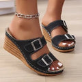 Women's creamy-white wedge beach slippers with a decorative belt buckle on the strap.