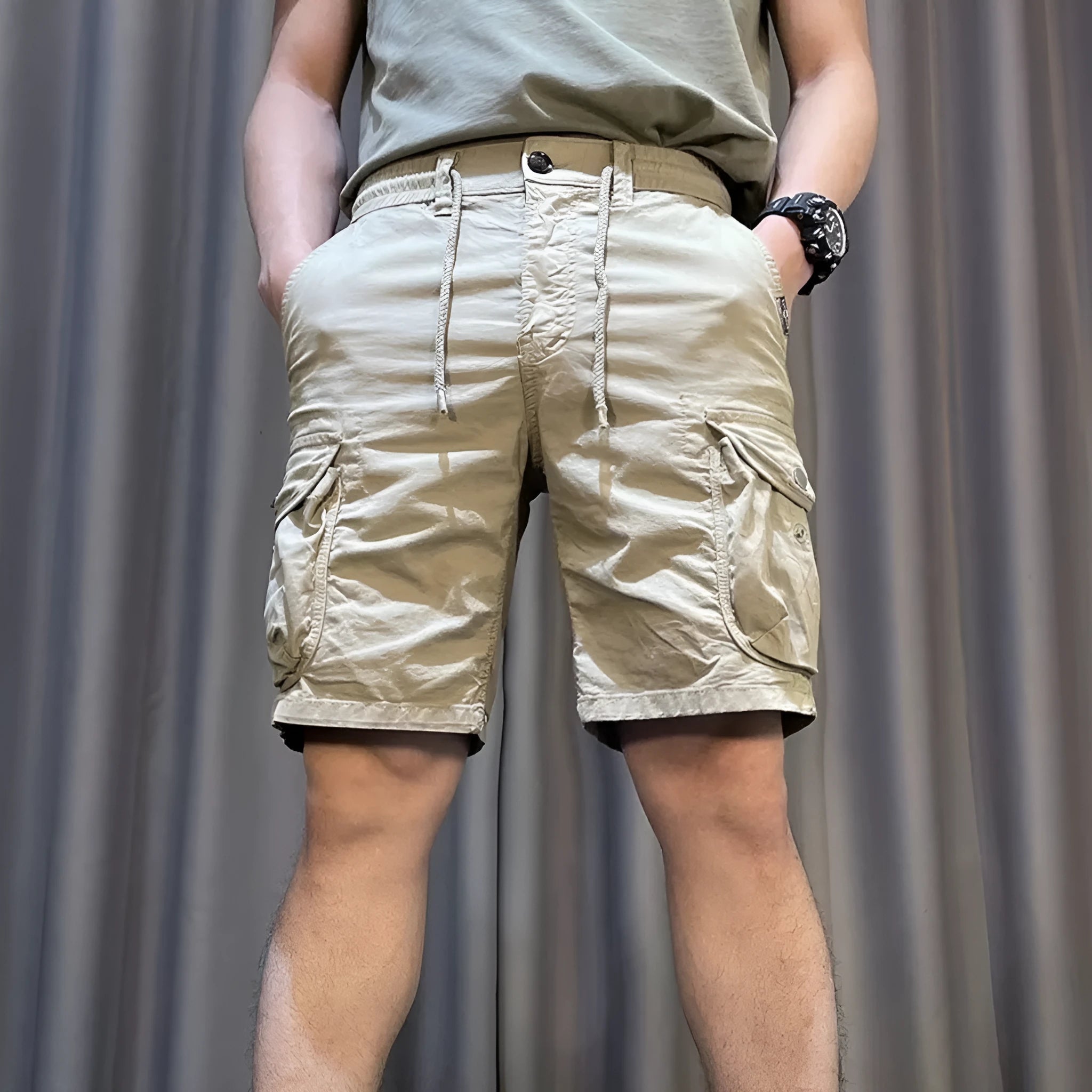 A pair of loose-fitting, straight-leg casual overalls in a khaki colour with multiple visible pockets.