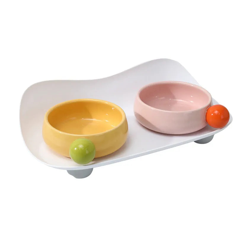 Ceramic double raised feeding bowl set for cats with non-slip support in pink, yellow, or pink yellow colour options