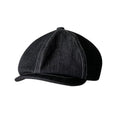 Black cotton beret with an octagonal cap style on a neutral background.