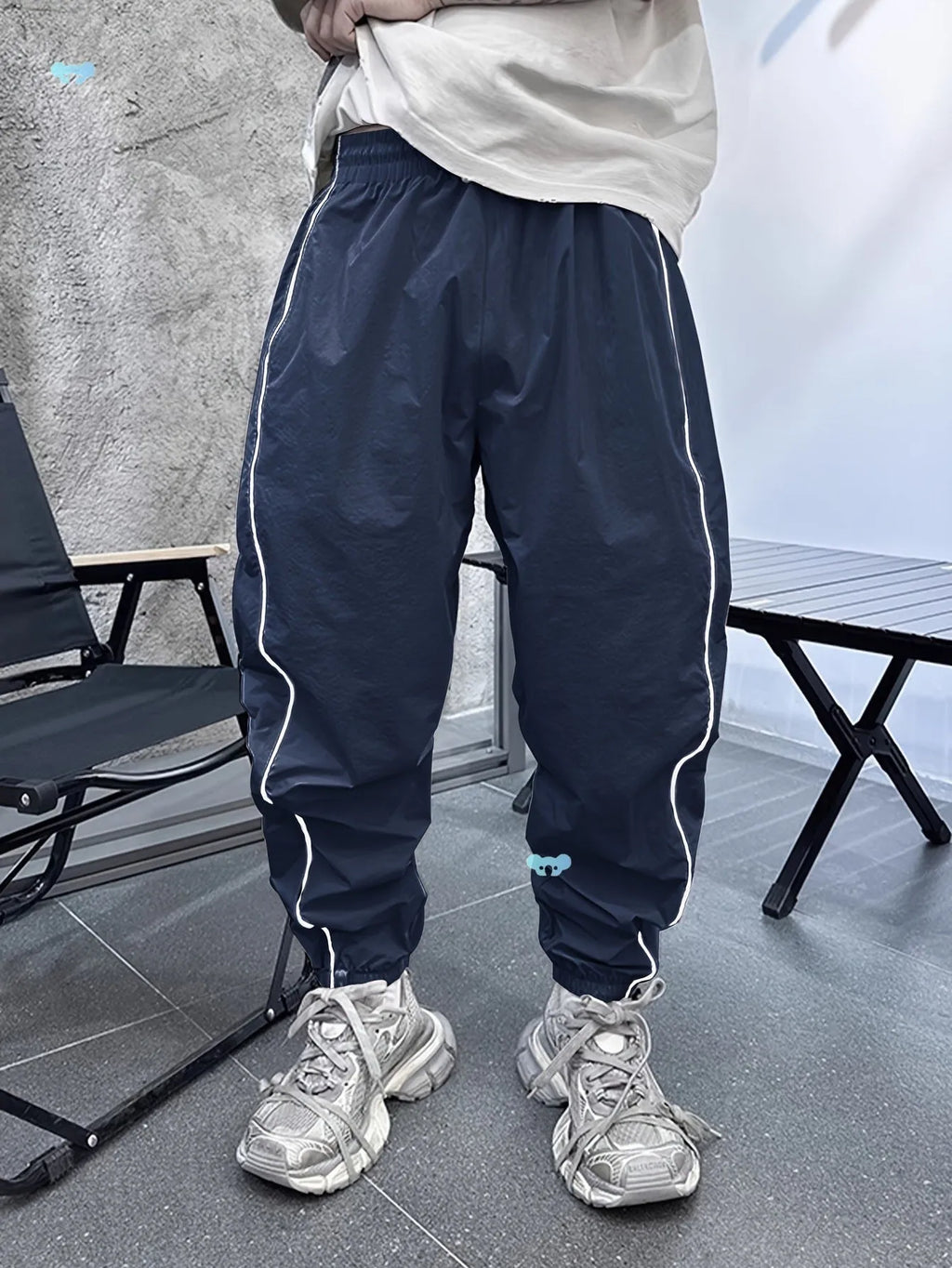 Men's blue bamboo fibre sports trousers with a loose, cropped fit and elastic waist.