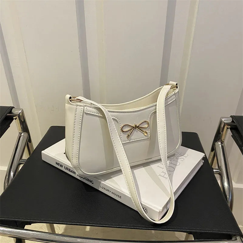 Western style baguette shoulder bag in horizontal square shape with bow decoration, shown in available colours