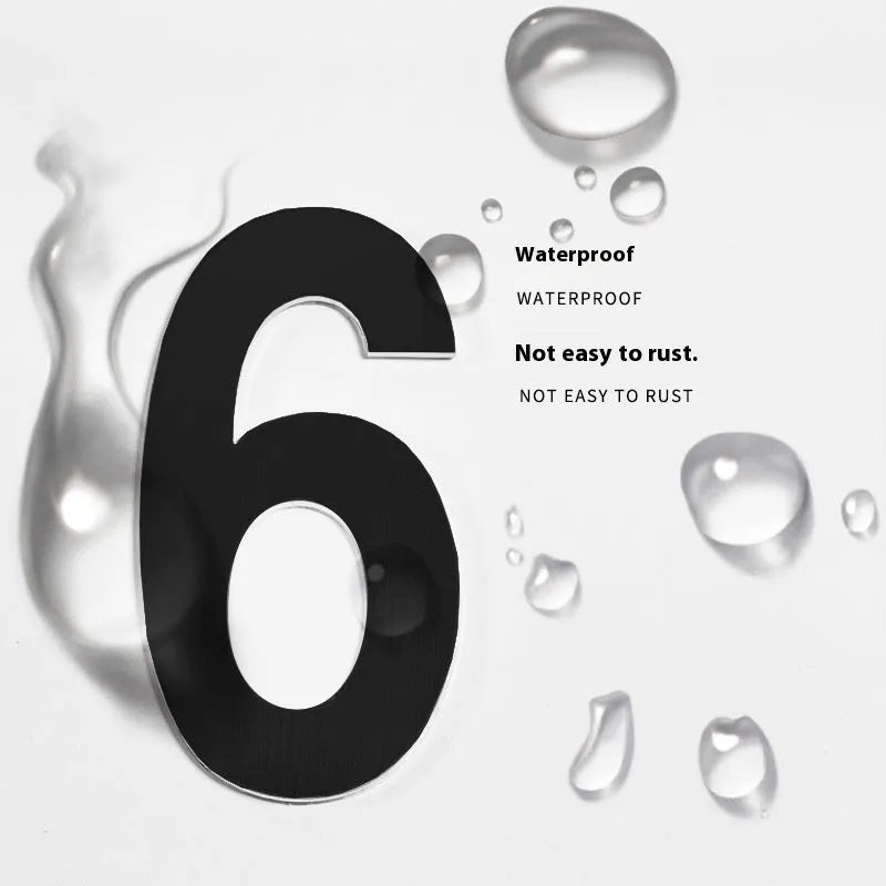 Black stainless steel sticky numbers and letters for a house address on a white background.