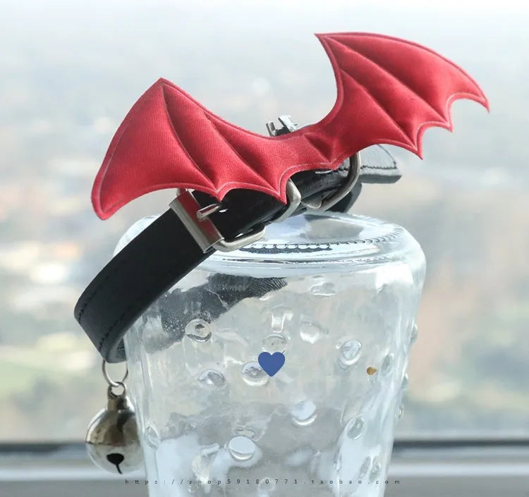 Black patent leather choker collar with devil wings design and bell attachment