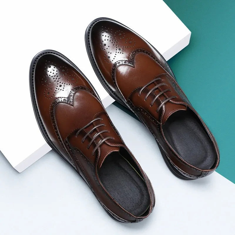 Men's black brogue leather shoes with decorative perforations and lace-up front.