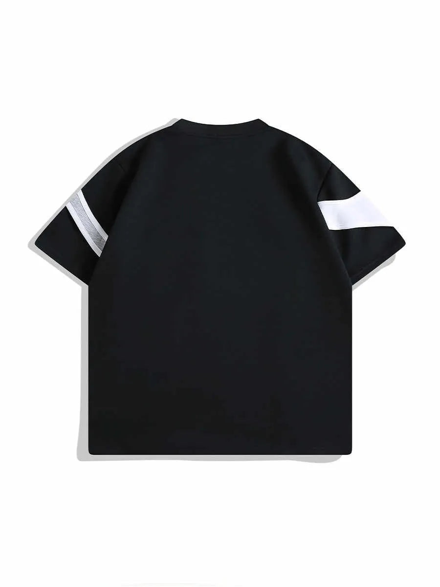 Loose black t-shirt showing double stitching detail forming a padded strap over the shoulder