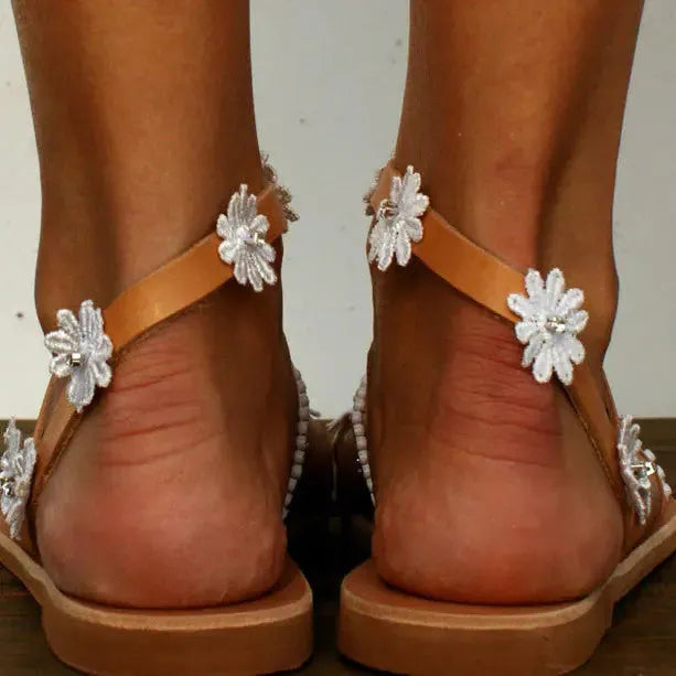 Brown women's Roman sandals with floral pattern and flat rubber sole