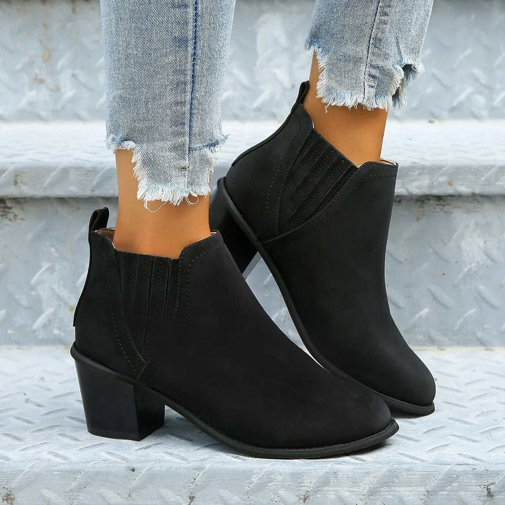 Women's black ankle boots with pointed toes and thick square low heels, slip-on design