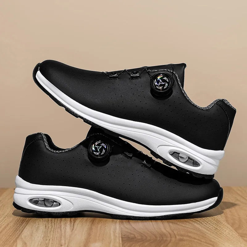 Low-top black and white casual tennis shoes with mesh upper and flat composite sole.
