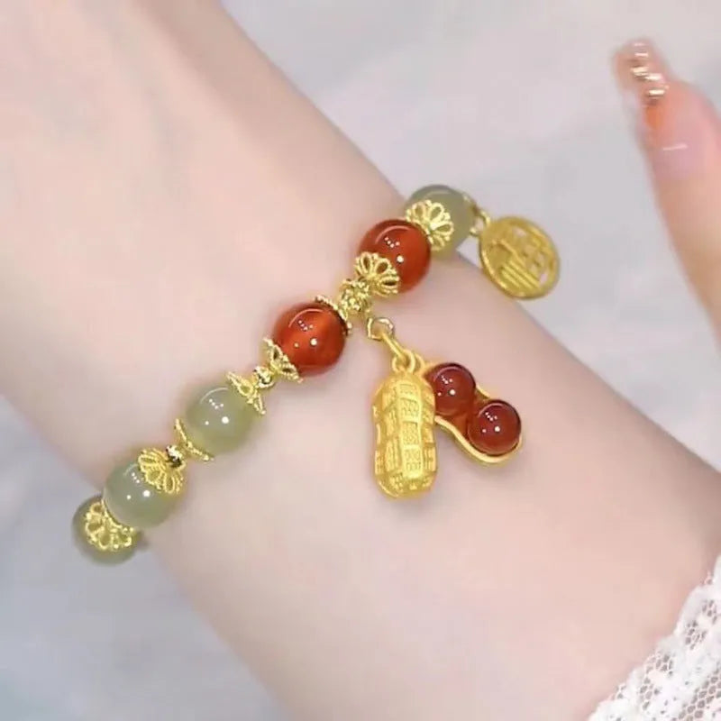 Chinese style handmade glass bead bracelet with bamboo joint elements on a white background.