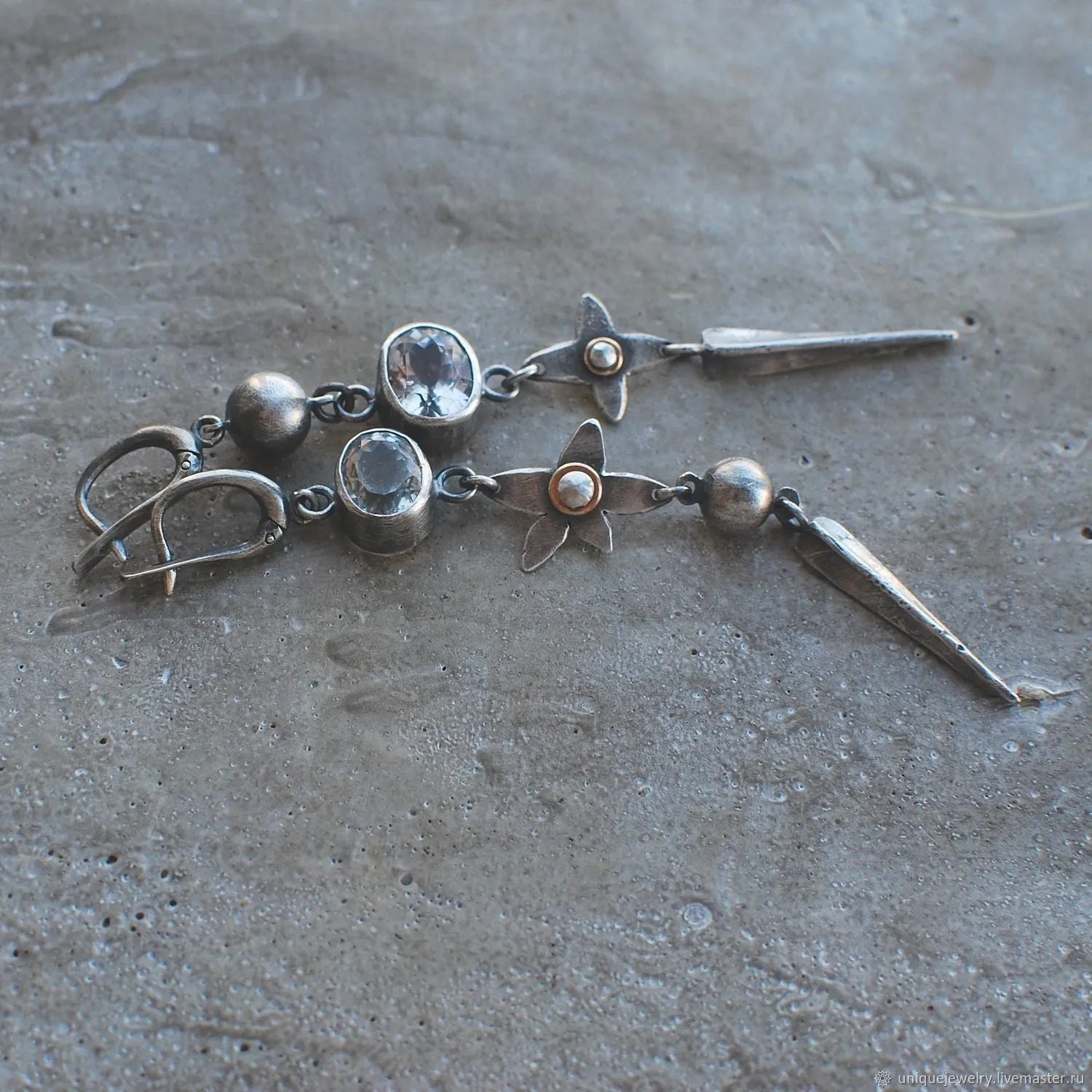 Geometric long pendant earrings in antique silver with rhinestone details on a stud.