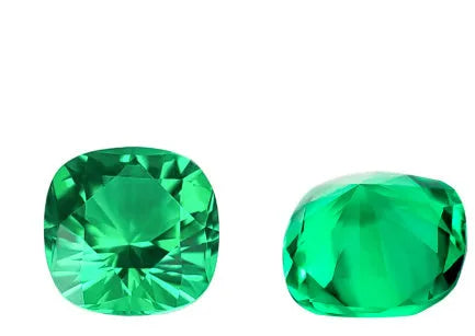 A loose cultivated emerald gemstone in Columbia green treasure colour on a white background.