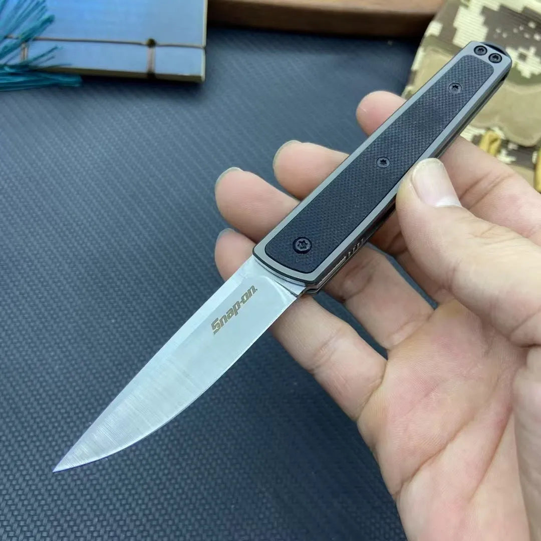 CRKT 7190 folding fruit knife showing blade and handle with colour options of black, brown, and red