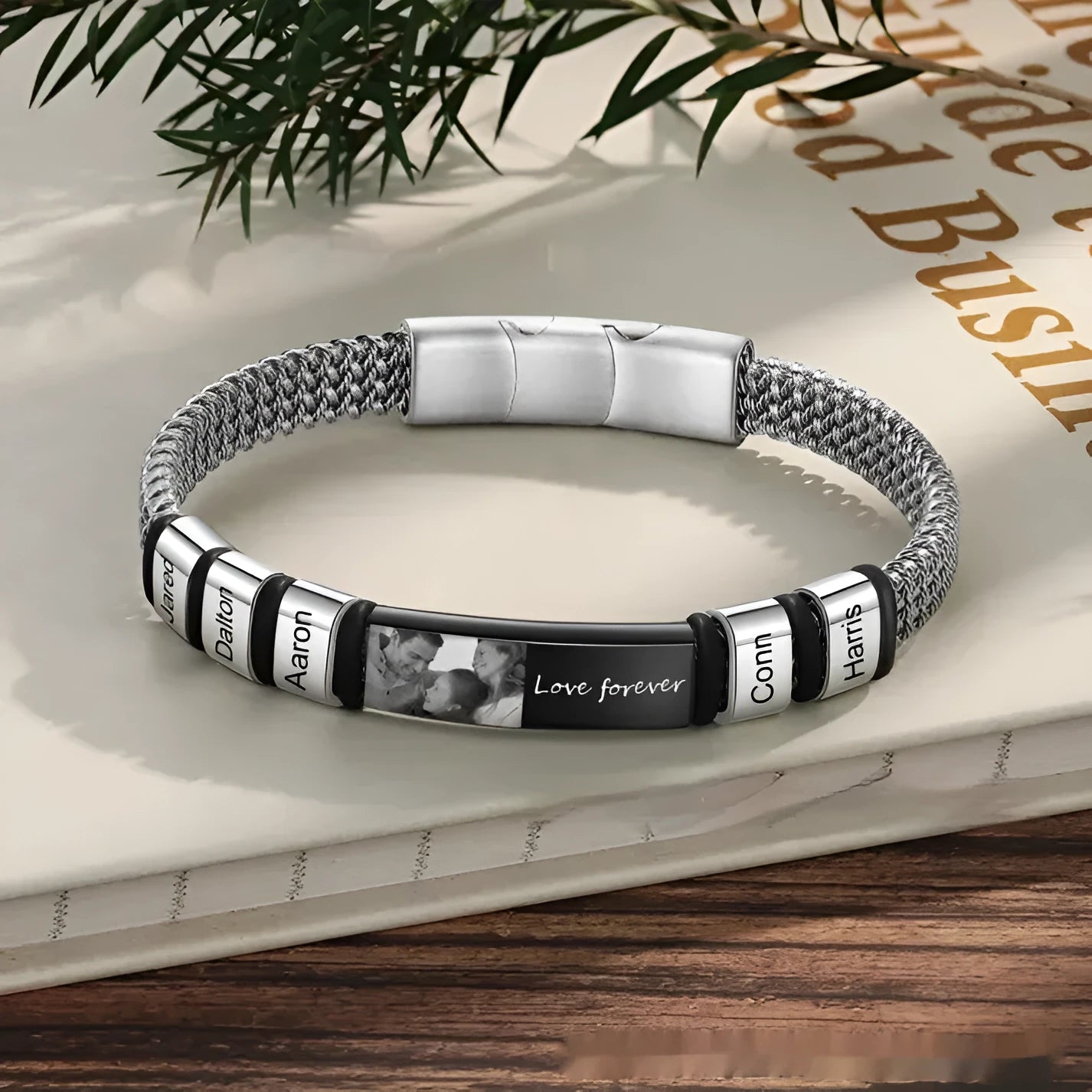 Men's titanium steel and leather rope bracelet with a heart-shaped lettering bead in a gift box.