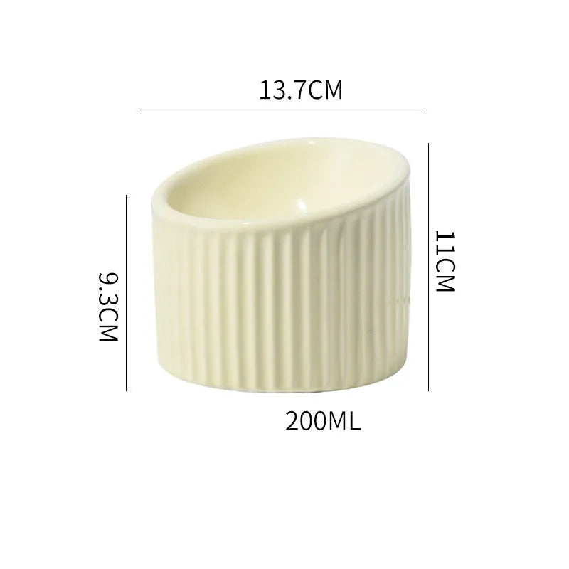 Ceramic elevated cat bowl in green colour, showing tilted design and raised feeding height.