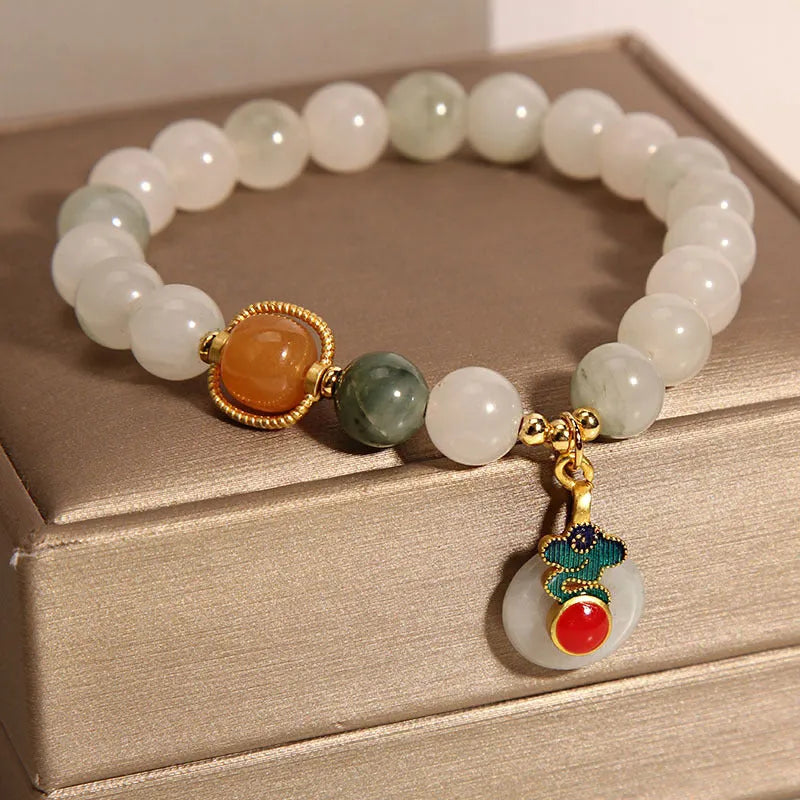 Women's ice jade crystal bracelet with xiangyun peace buckle and pearl accents on a retro-style chain.