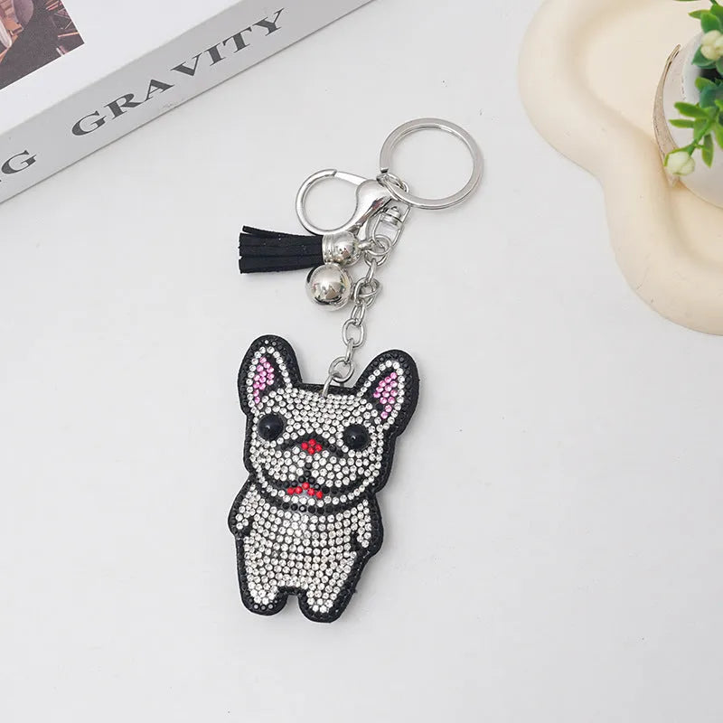Close-up of a cartoon dog rhinestone keychain pendant on an alloy keyring