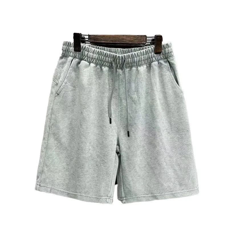 Men's cotton distressed shorts in loose straight-leg fit showing navy blue, mud lime, ash black and grass green colour options