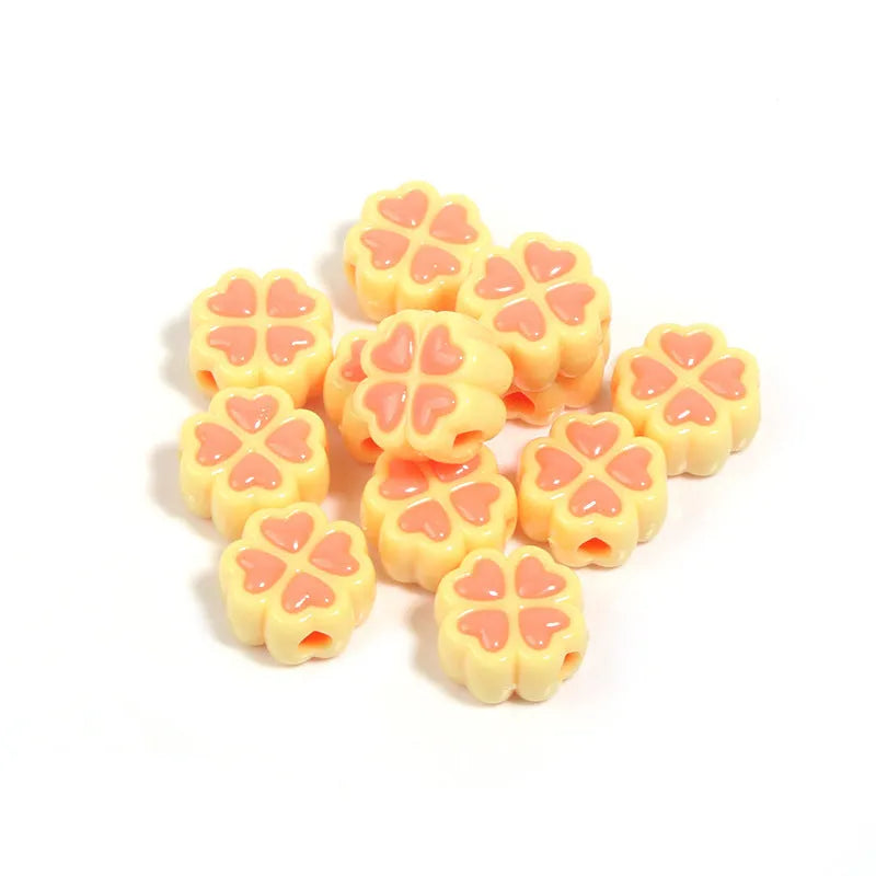 Acrylic clover craft beads with frosted finish in mixed colours including pink, blue and green
