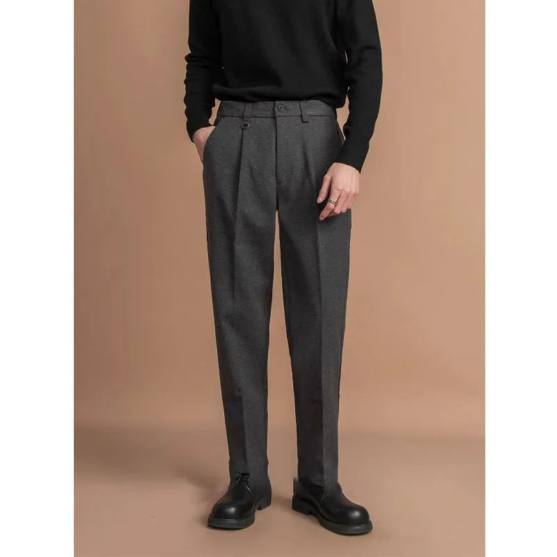 Men's straight-leg polyester trousers in black, shown in a business casual setting.