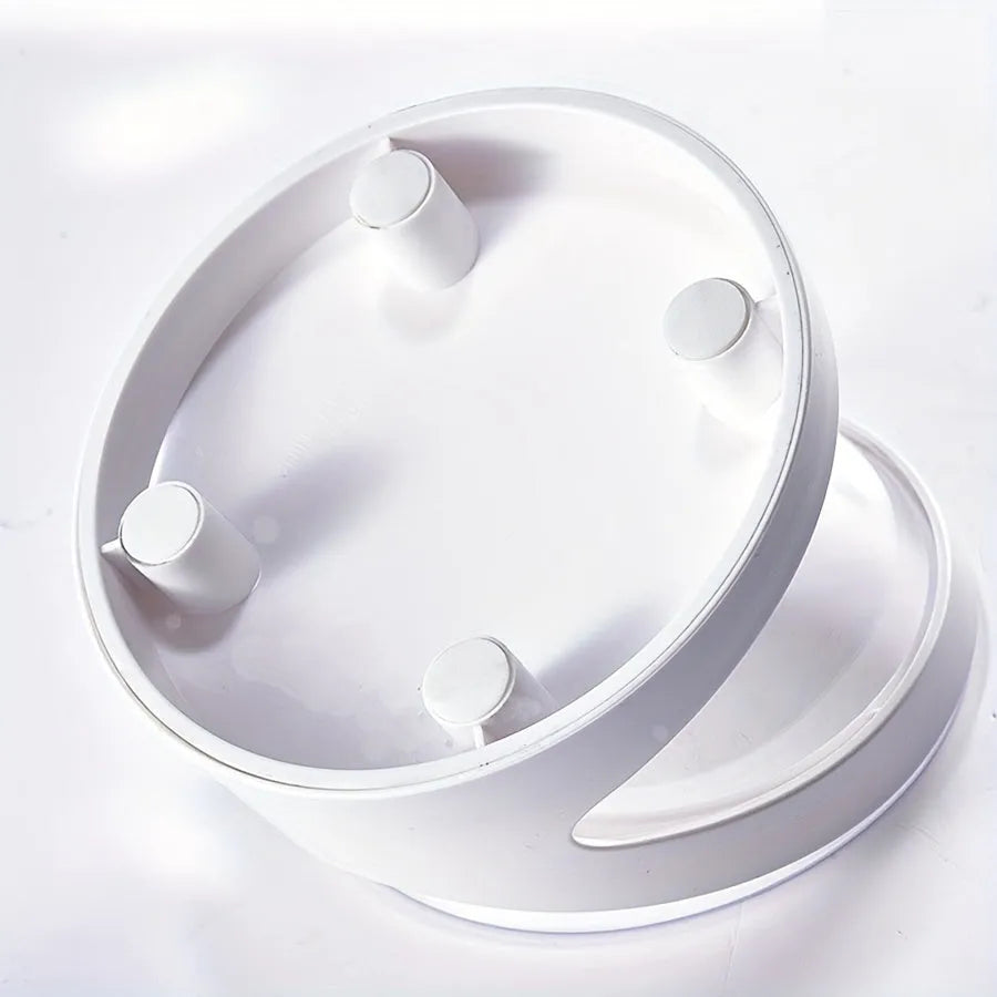 White clear plastic tilted cat food bowl on a flat surface.