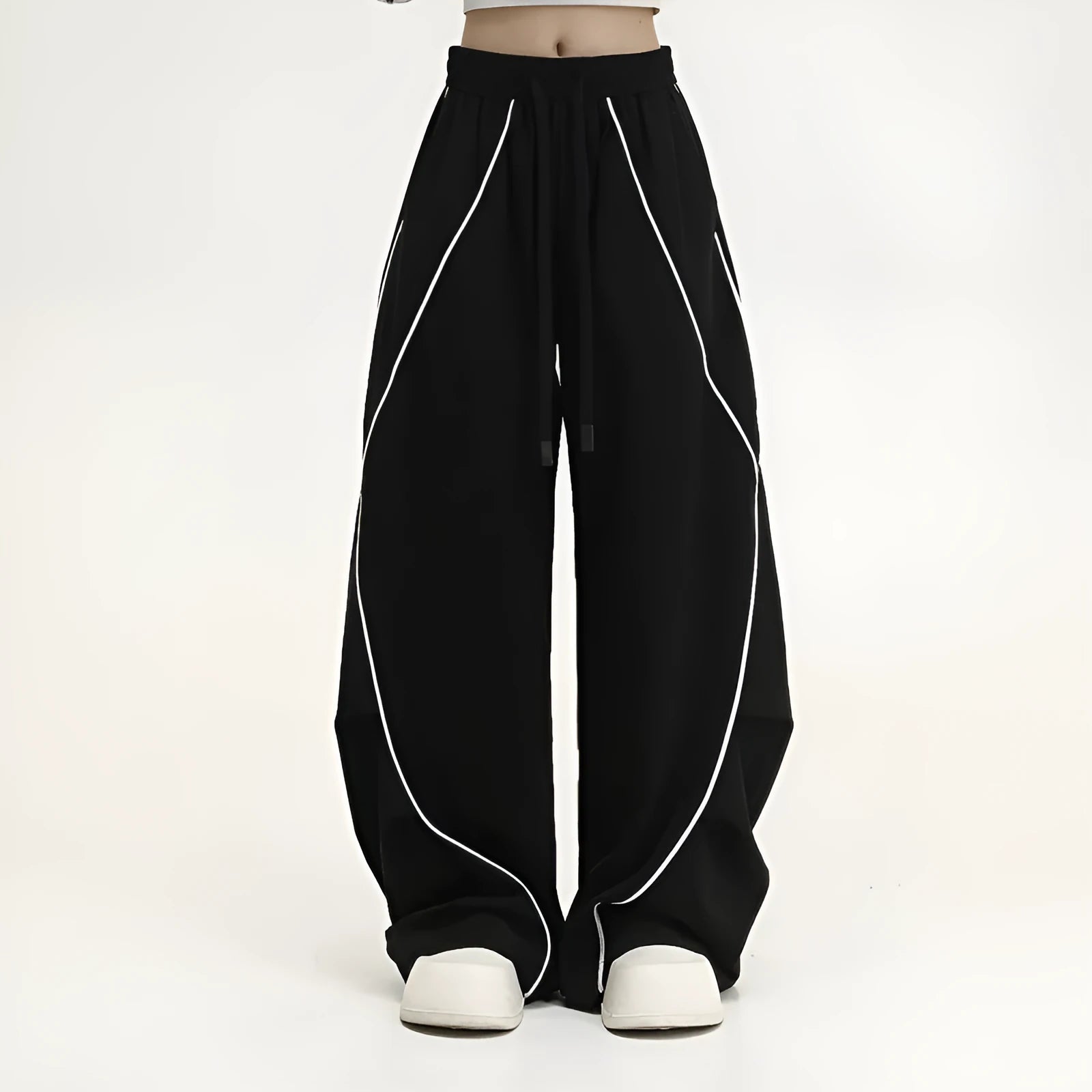 Black pleated wide-leg trousers with stripe pattern showing loose fit and mid waist design
