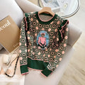 Green printed loose-fit women's jumper with regular sleeves on a hanger