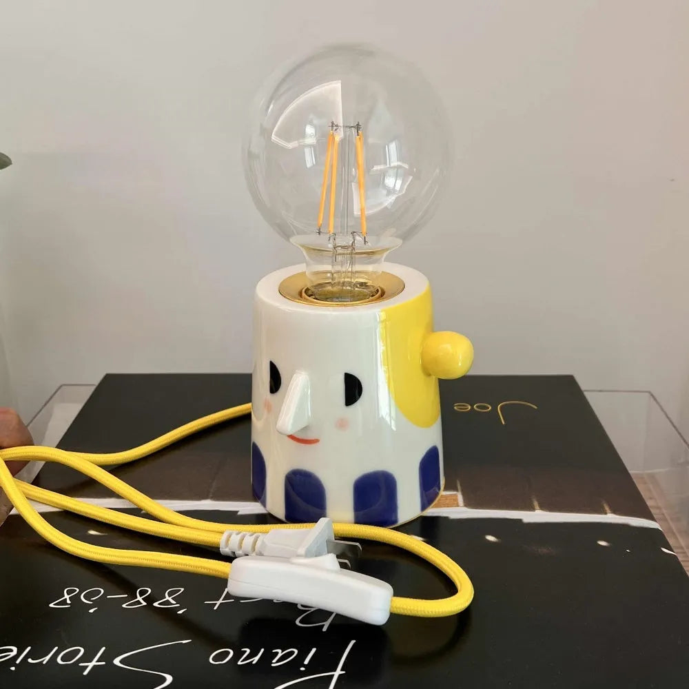 Handmade ceramic table lamp with ball headlight design on bedside table
