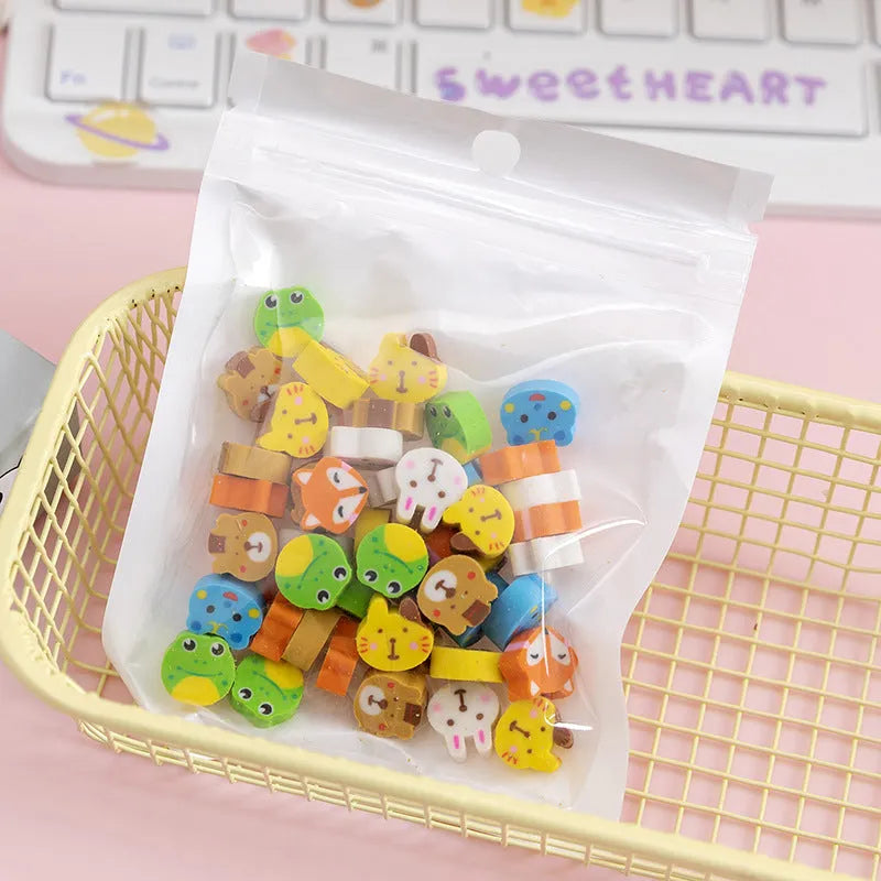 Open pearlescent film bag showing 50 small colourful cartoon fruit-themed rubber erasers.