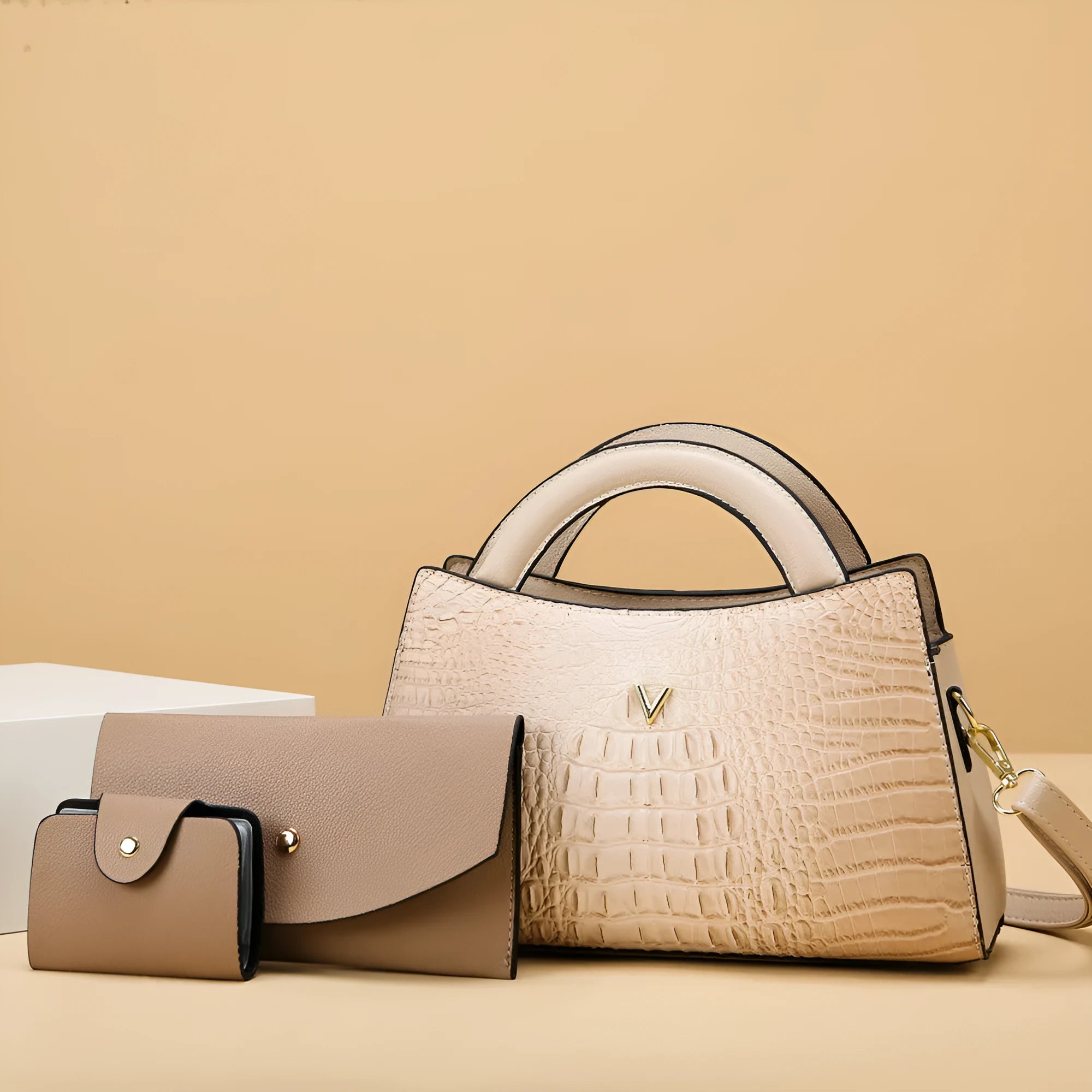 Women's square black crossbody handbag with crocodile pattern texture, showing front zip and adjustable strap.
