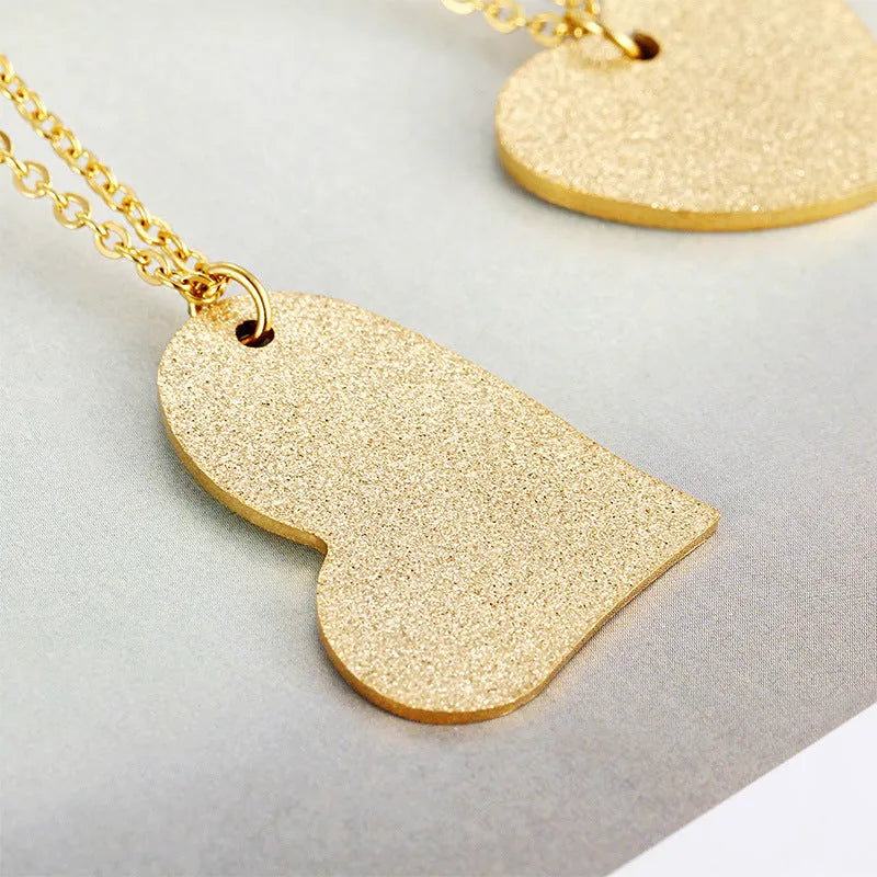 Geometric heart-shaped titanium steel pendant necklace on model, simple fashion style
