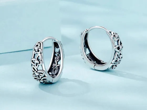 Sterling silver hollow butterfly earrings with zircon accents measuring 14mm by 5mm