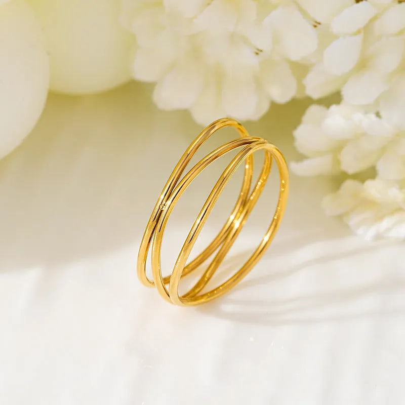 Geometric three-layer coil ring with gold electroplated finish on titanium steel