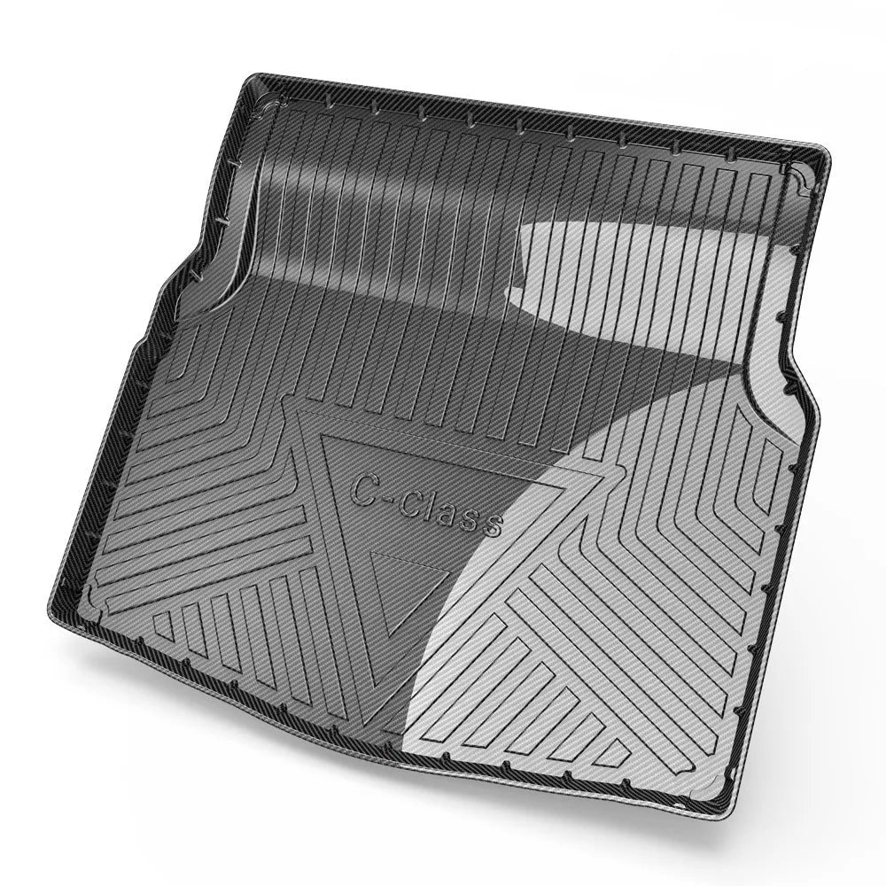 Black carbon fibre pattern TPE trunk pad installed in a car boot showing custom fit and textured surface