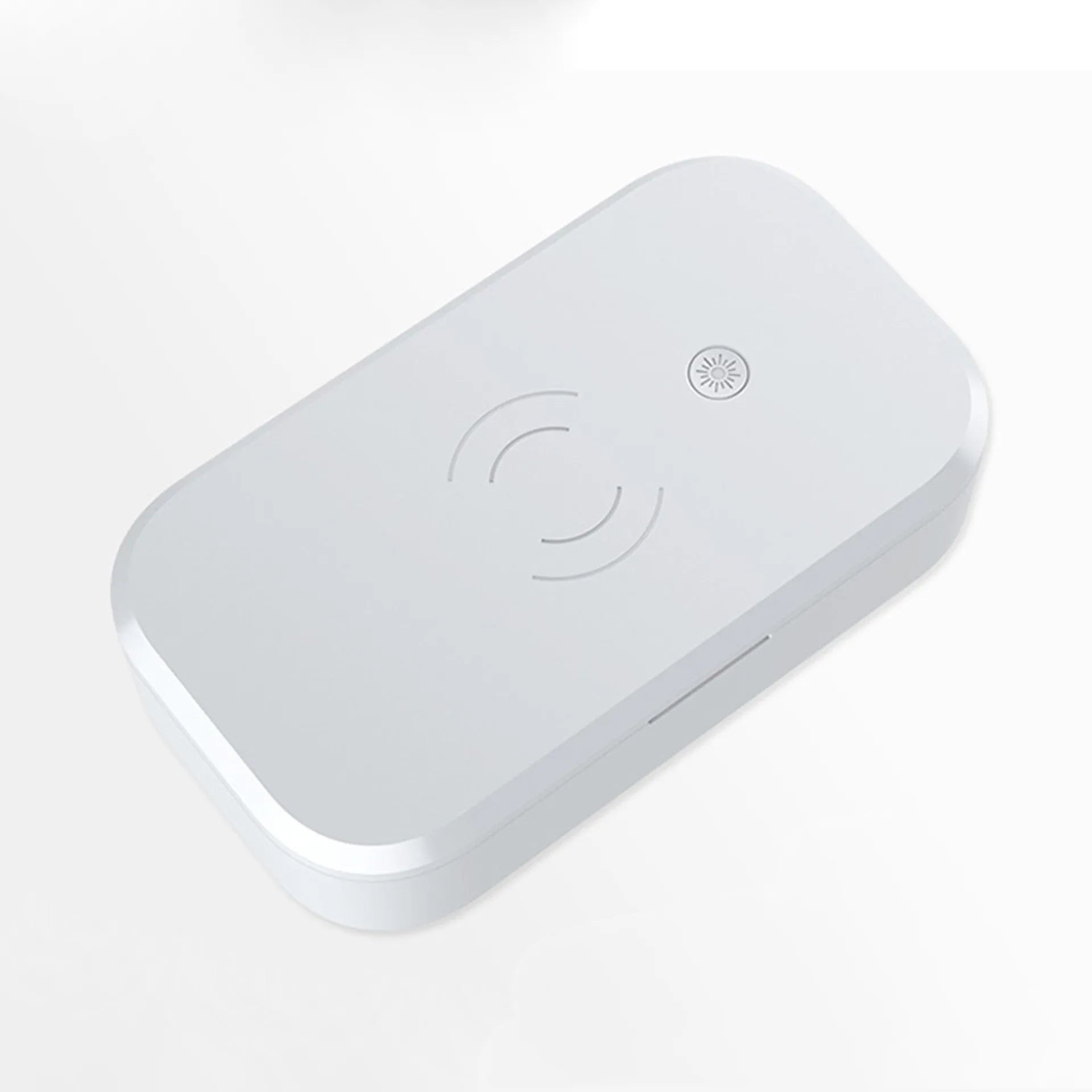 White UV disinfection box with wireless charging pad for phones and nail tools.