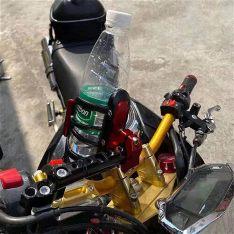 Black water bottle cage mounted on Honda X-ADV scooter bumper with mounting bracket visible