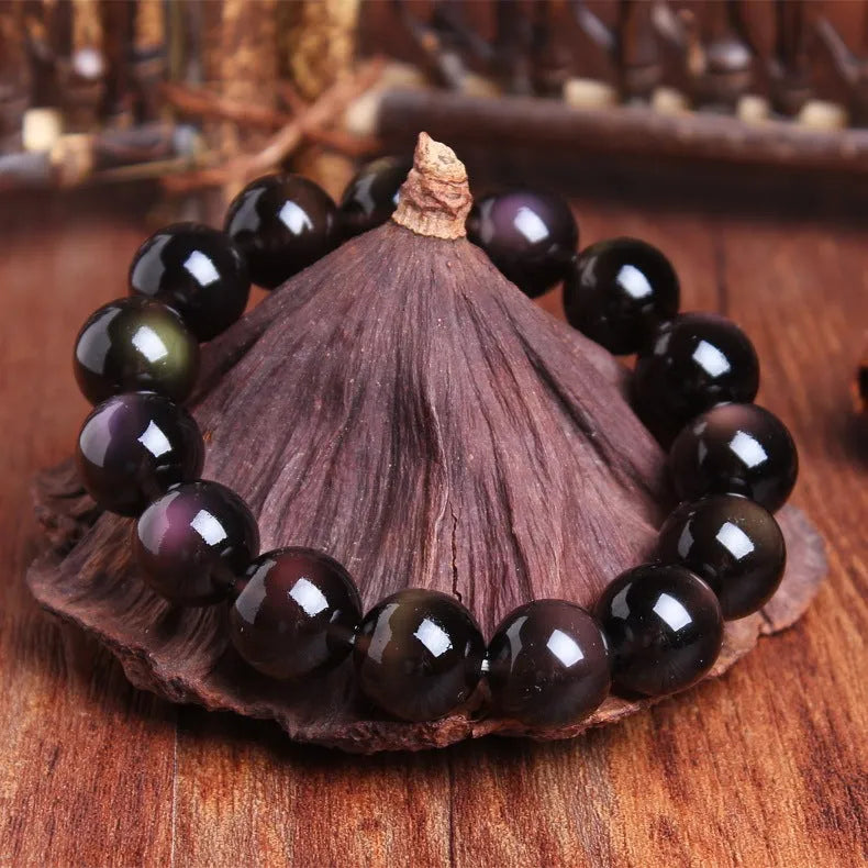 Polished crystal Pi Xiu bracelet on wrist, showing ethnic geometric style and Icy Obsidian colour.