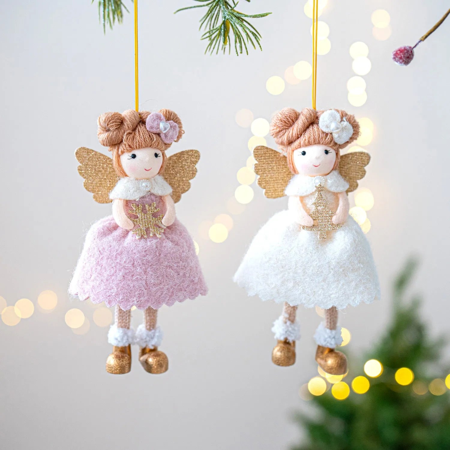 Pink and white cloth angel wings plush Christmas pendant ornament on a branch