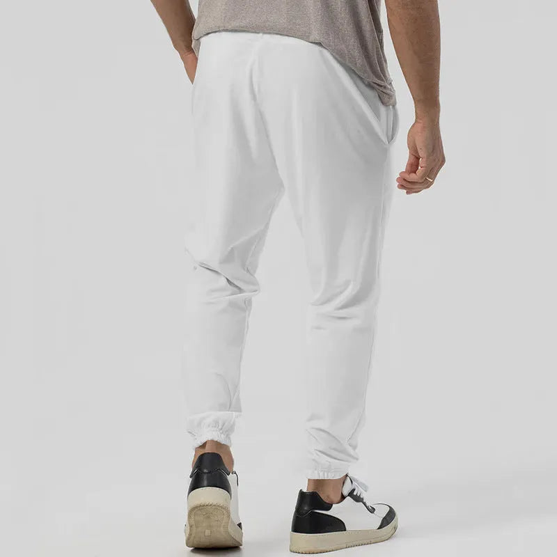 Men's grey straight-leg casual sweatpants with elastic waistband, shown laid flat.