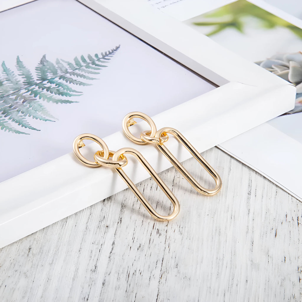 Geometric sterling silver needle colour hoop drop earrings with ring and line design on a white background.