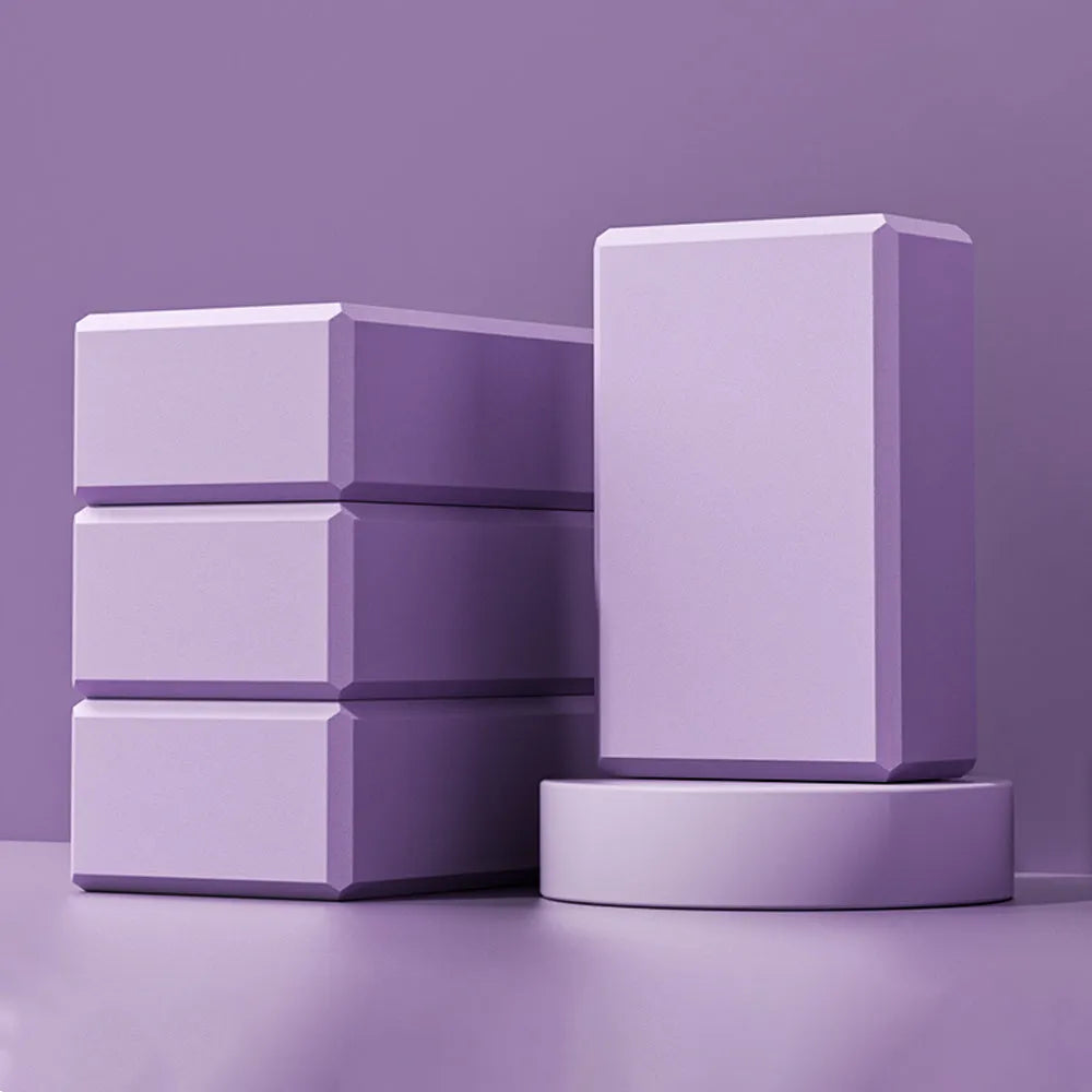 Solid colour EVA foam yoga brick block with hexagonal facets for grip, measuring 23x15x7.6cm.