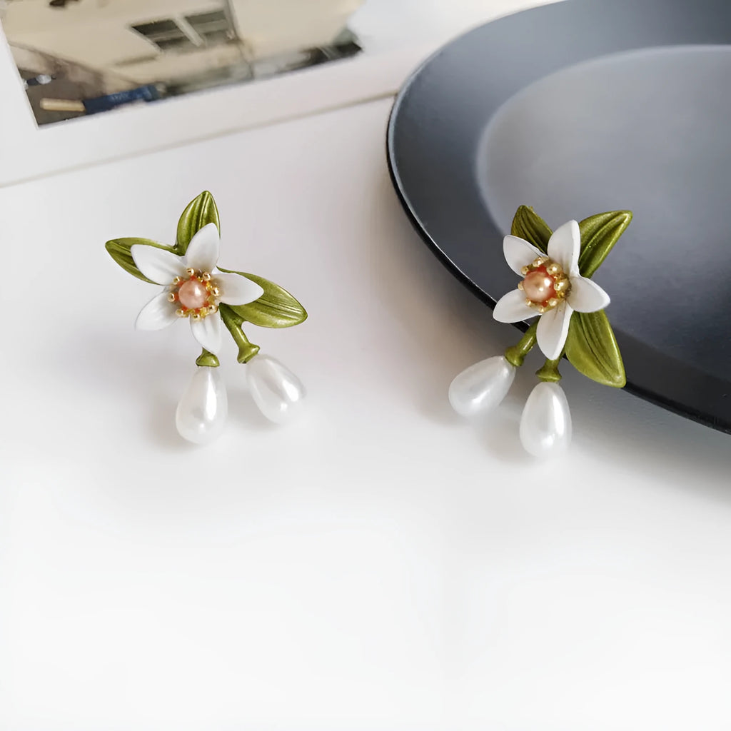 Women's alloy flower earrings with sterling silver needle contrasting colour detail, shown in clip-on and stud styles