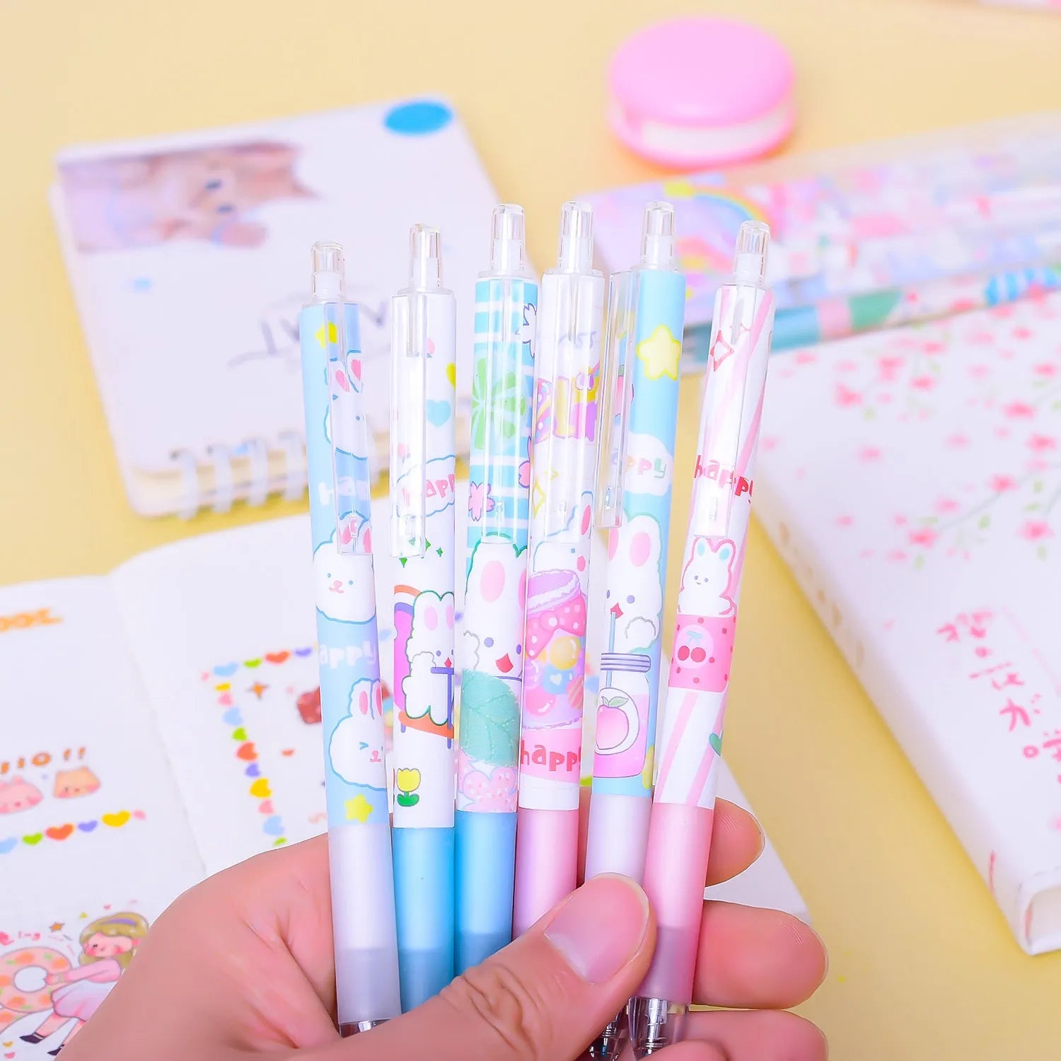 Six Cartoon Bunny brand black plastic pens with 0.5mm tips laid out from their box.